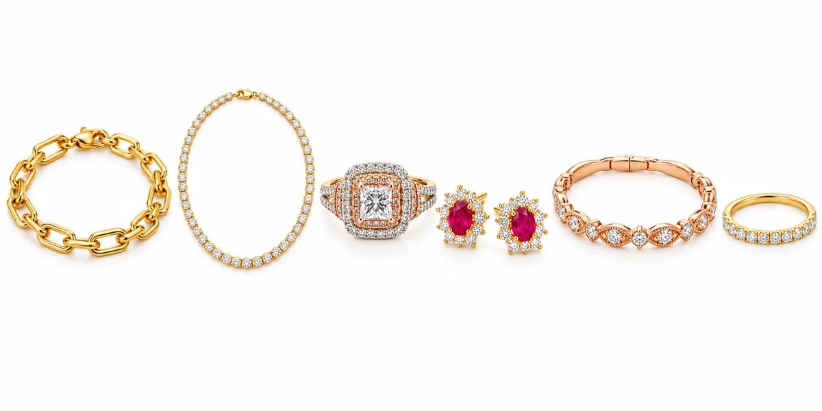 Yellow gold, rose gold and diamond jewelry arranged on white