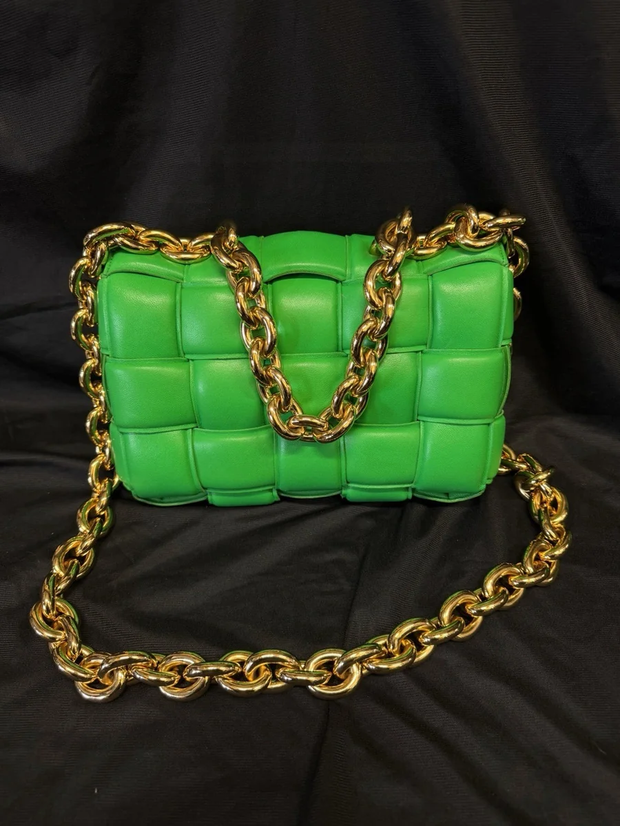 Close-up of a Bottega Veneta Padded Cassette bag in green lambskin with the Intrecciato weave and gold chain strap, bought and authenticated by San Diego Jewelry Buyers