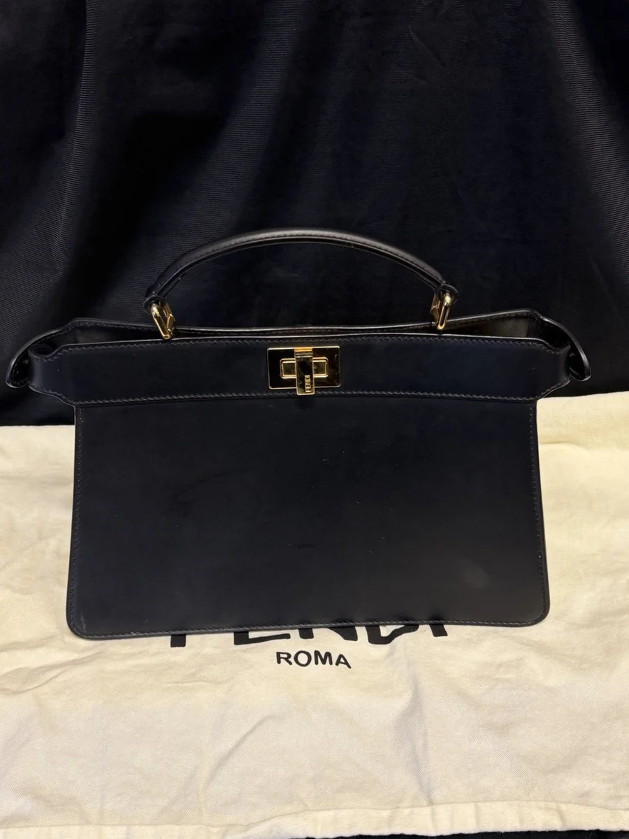 Close-up of a Fendi Peekaboo I See U bag in black leather with beaded fringe and the twist clasp, bought and authenticated by San Diego Jewelry Buyers