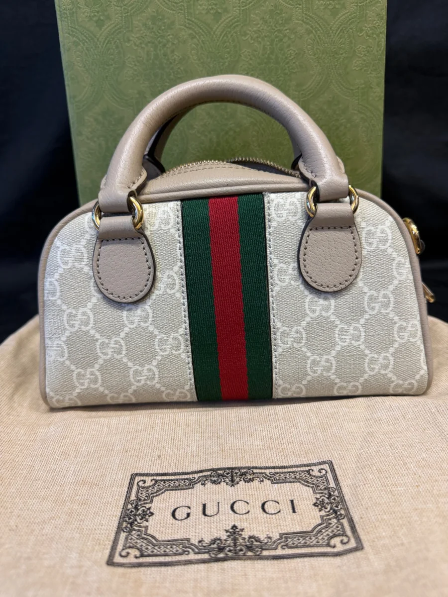 Close-up of a Gucci Ophidia mini bag in beige GG Supreme canvas with the green and red web stripe and the interlocking double-G, bought and authenticated by San Diego Jewelry Buyers