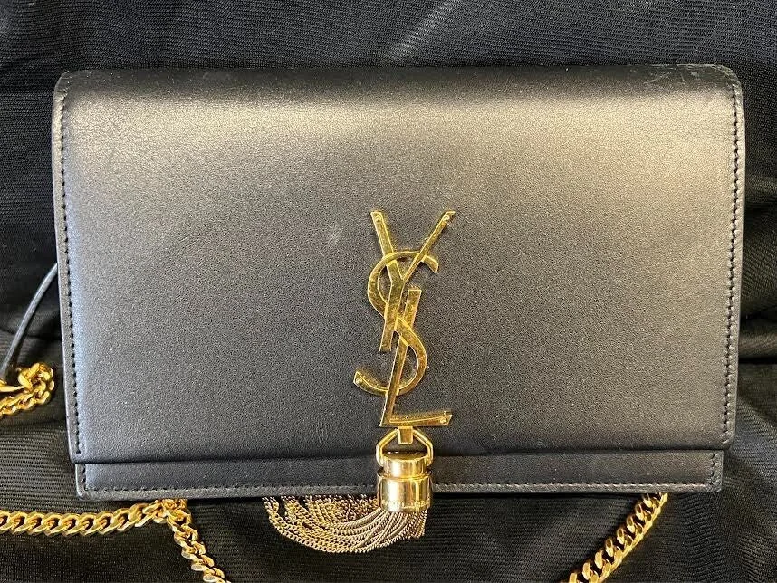 Saint Laurent Classic Kate shoulder bag in black leather with the gold YSL cassandre monogram and tassel, bought and authenticated by San Diego Jewelry Buyers