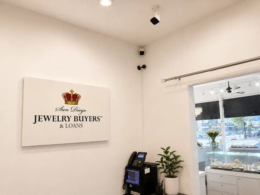 Reception area with the San Diego Jewelry Buyers wall sign